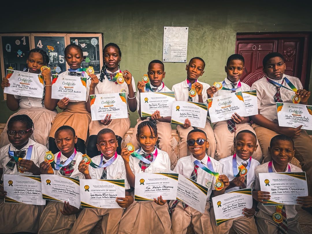White Cloud School pupils proudly holding their National Mathematics Festival certificates and medals